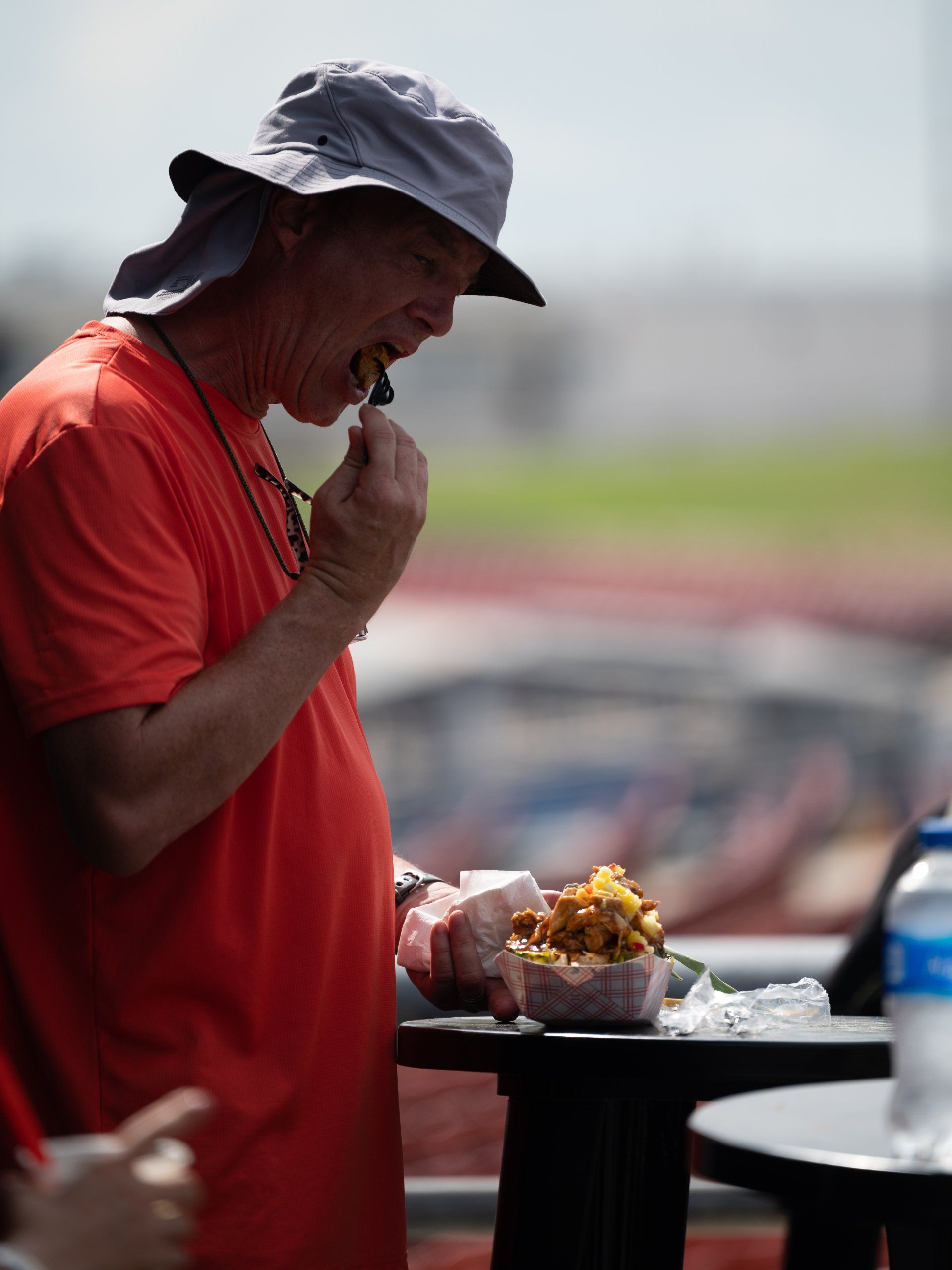A fan taking a bite of the pineapple bowl at Circuit of the Americas